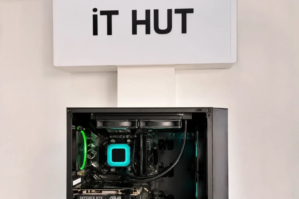 Gaming desktop PC displayed inside iT HUT Computers, a computer store offering custom PCs, gaming accessories, and computer hardware.